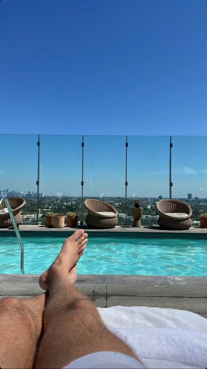 Eyal Booker barefoot by the pool